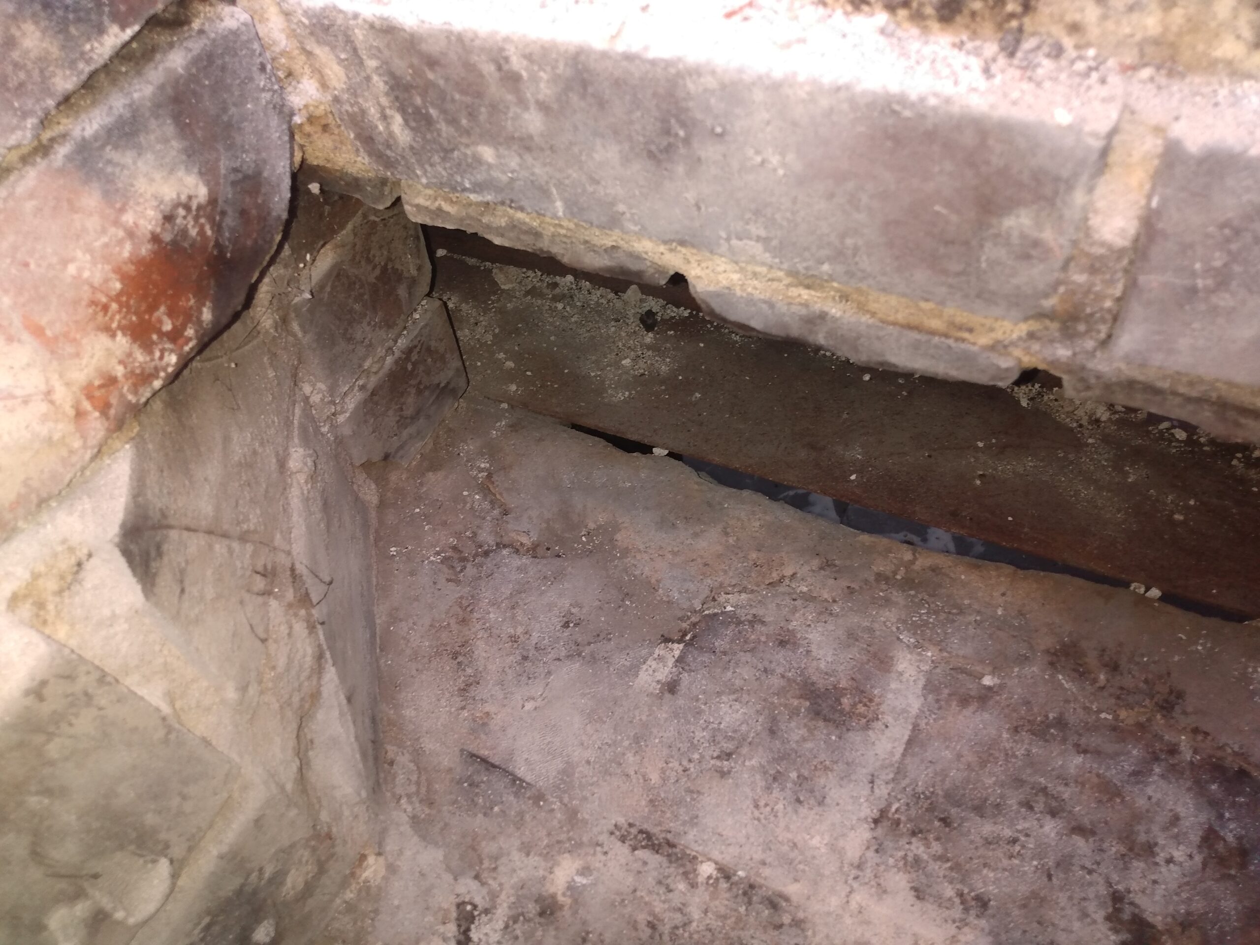 Chimney smoke chamber exposed for repairs.
